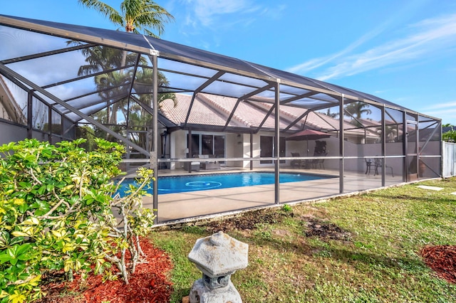 view of pool with glass enclosure and a patio