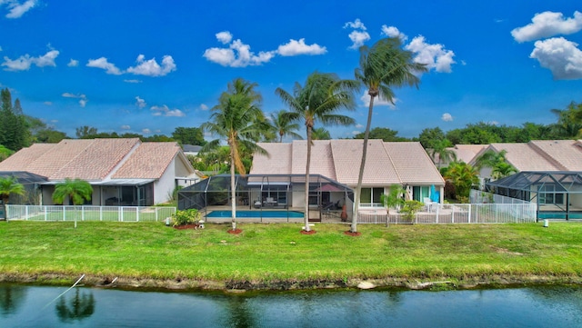 back of property with a lanai, a water view, a yard, and a fenced in pool