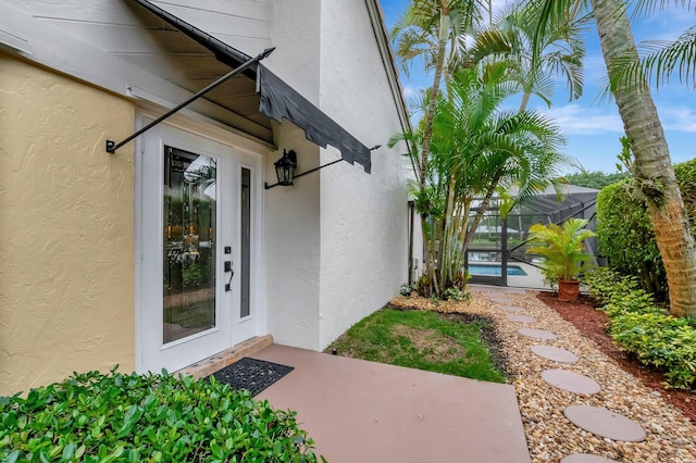 view of exterior entry featuring a patio