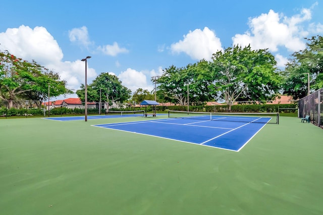 view of tennis court featuring basketball court