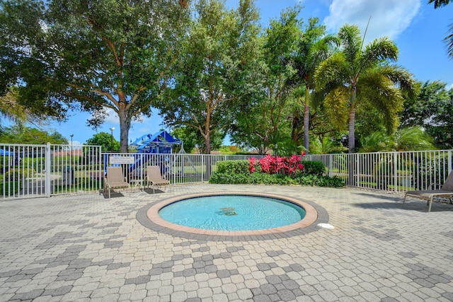 view of swimming pool featuring a patio area