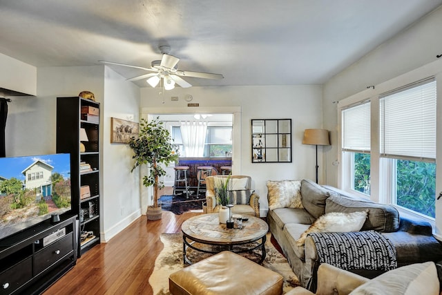 living room featuring ceiling fan, a wealth of natural light, and hardwood / wood-style flooring