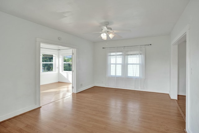 empty room featuring ceiling fan and light hardwood / wood-style floors