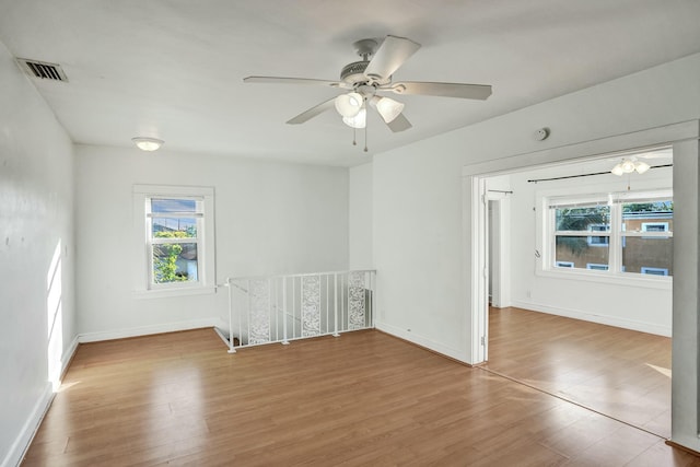 unfurnished room with ceiling fan and hardwood / wood-style floors