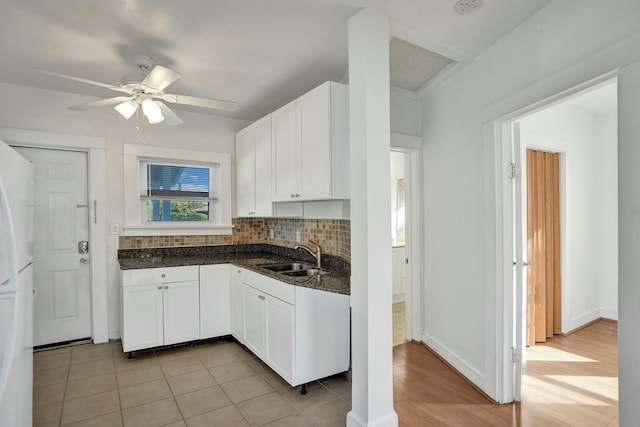 kitchen with sink, ceiling fan, white cabinetry, and light tile patterned floors