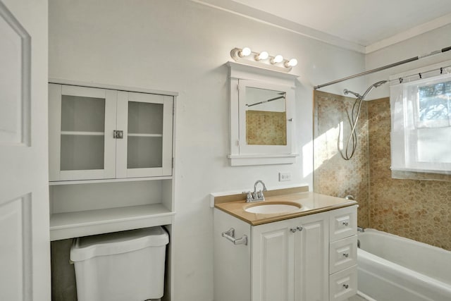 full bathroom featuring tiled shower / bath, vanity, and toilet