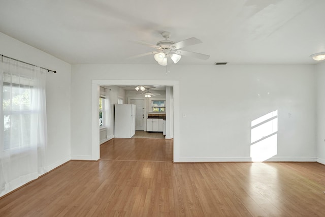 spare room with ceiling fan and light hardwood / wood-style flooring