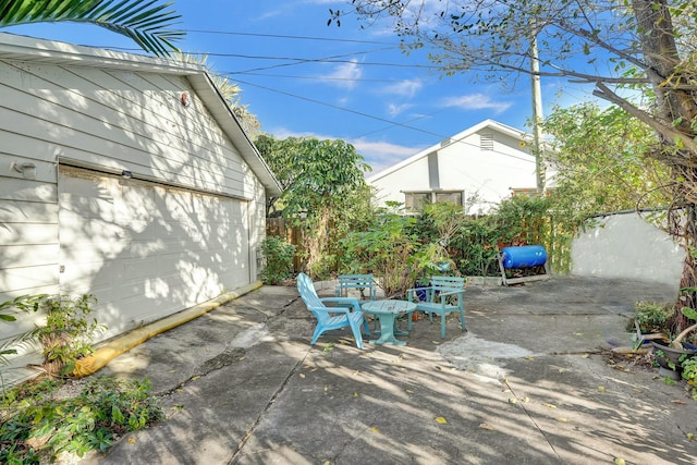 view of patio featuring a garage and an outdoor structure