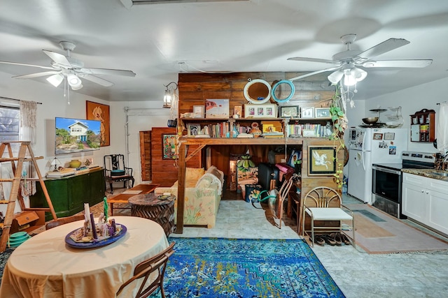 interior space featuring wood walls and ceiling fan