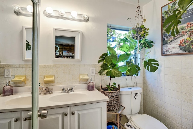 bathroom featuring tile walls, vanity, and toilet