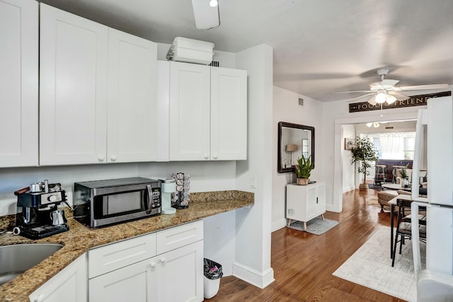 kitchen featuring white cabinetry, stone countertops, and dark hardwood / wood-style floors