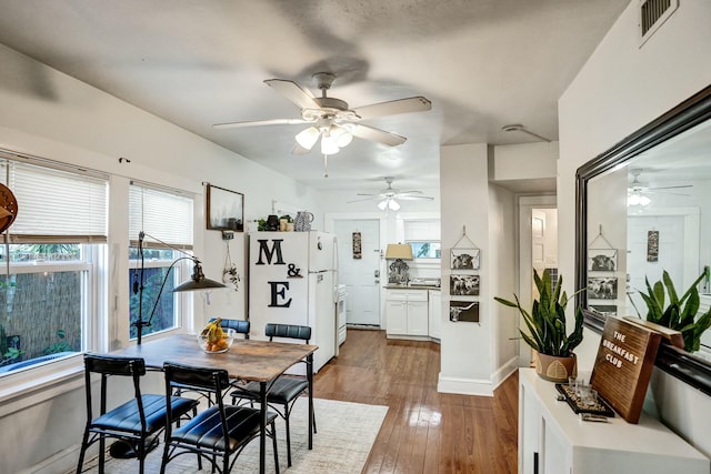 dining space with ceiling fan and dark hardwood / wood-style floors