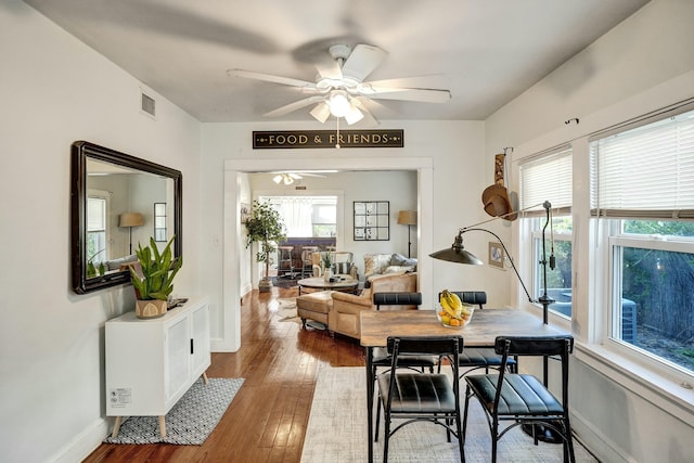 dining space with ceiling fan and hardwood / wood-style floors