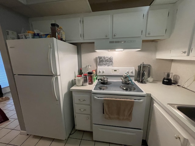 kitchen with white refrigerator, white cabinets, light tile patterned floors, exhaust hood, and range with electric stovetop