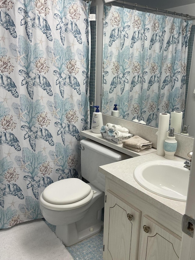 bathroom featuring toilet and vanity