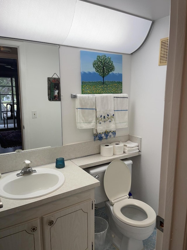 bathroom with toilet and vanity