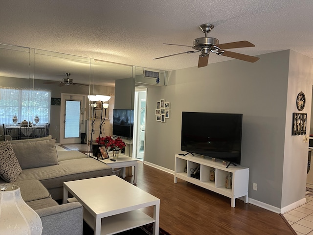 living room featuring a textured ceiling, ceiling fan, and hardwood / wood-style floors