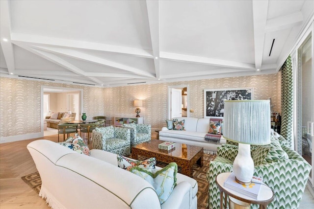 living room featuring beamed ceiling and parquet floors