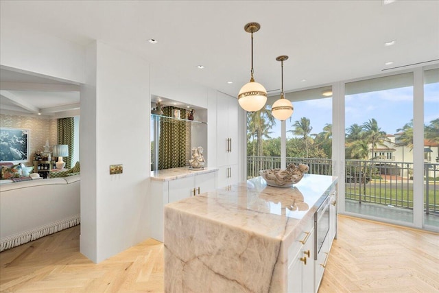 dining area with floor to ceiling windows and light parquet flooring