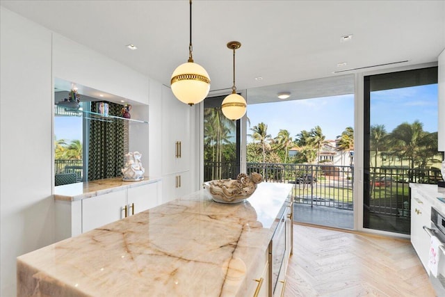 dining space featuring light parquet floors and a wall of windows