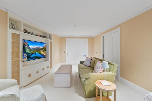 carpeted living room with built in shelves and ornamental molding