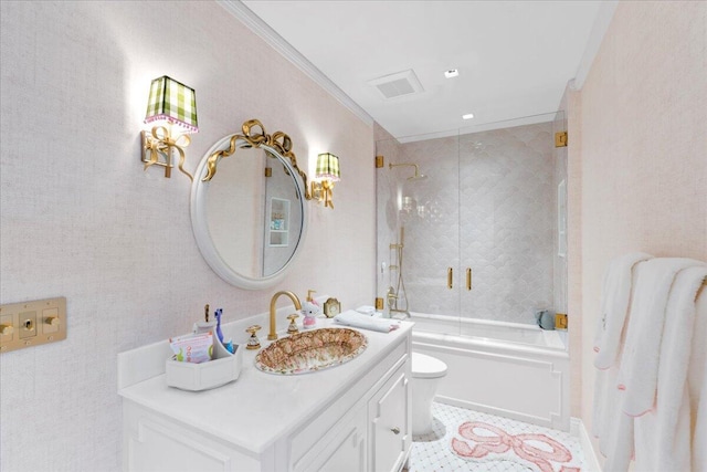 full bathroom with vanity, tile patterned floors, combined bath / shower with glass door, toilet, and ornamental molding