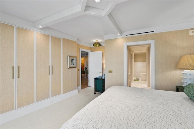 bedroom with beamed ceiling, ensuite bathroom, crown molding, and light colored carpet