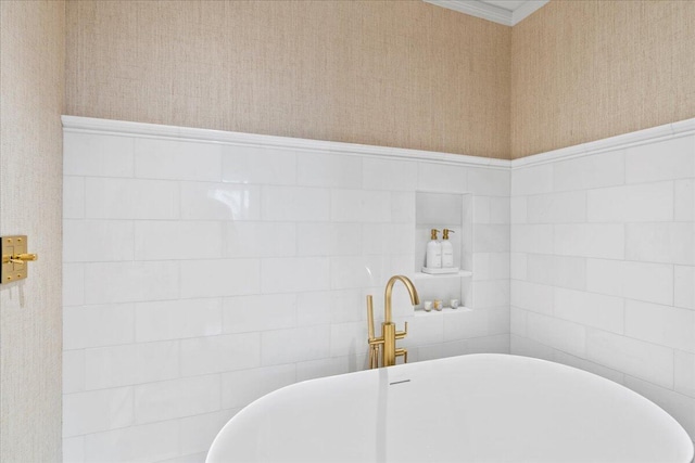 bathroom with a washtub and tile walls