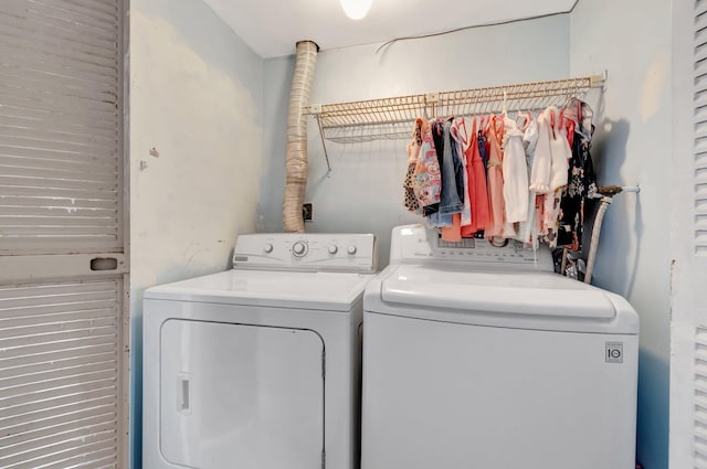 clothes washing area with washing machine and dryer