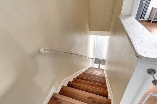 staircase featuring hardwood / wood-style flooring