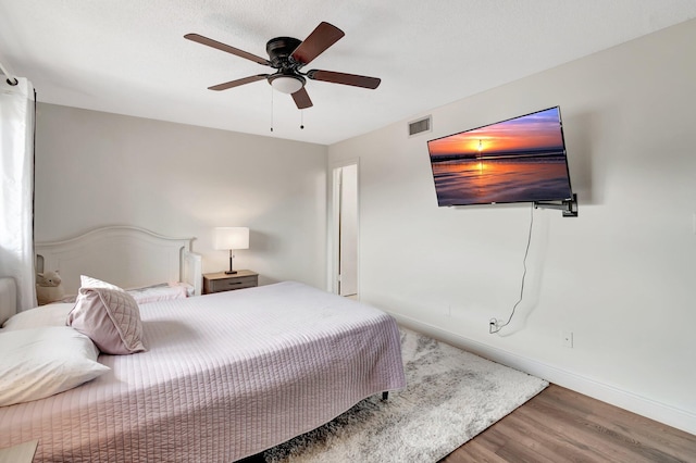 bedroom featuring hardwood / wood-style flooring and ceiling fan