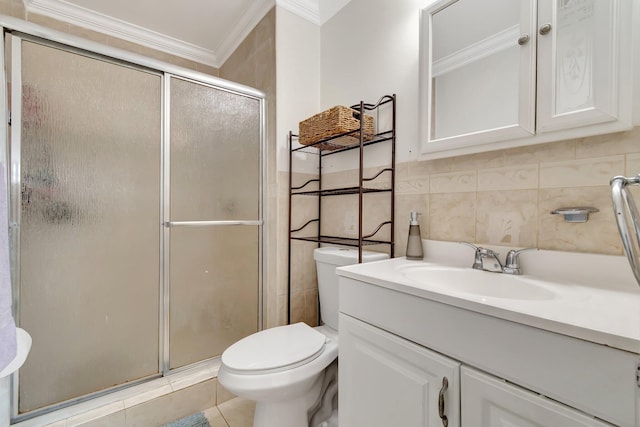 bathroom featuring vanity, crown molding, toilet, tile walls, and a shower with shower door