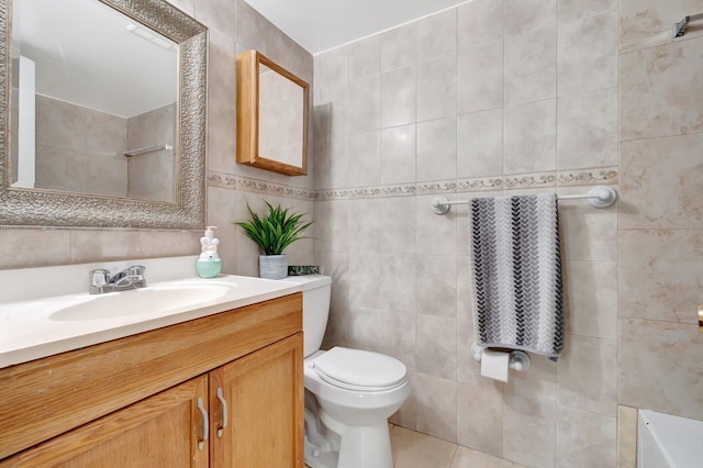 bathroom with tile patterned flooring, vanity, toilet, and tile walls