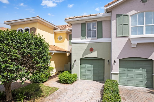 view of front of home featuring decorative driveway and stucco siding