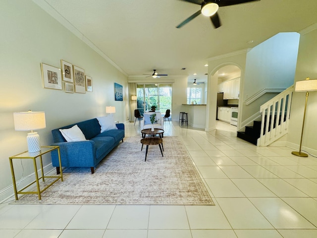 living room featuring ceiling fan, ornamental molding, and light tile patterned floors