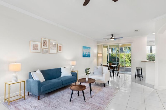 living room featuring light tile patterned floors, ornamental molding, visible vents, and baseboards