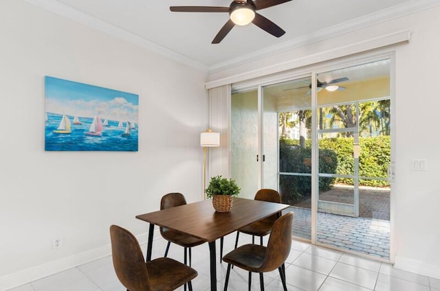 dining room featuring light tile patterned floors, baseboards, and crown molding