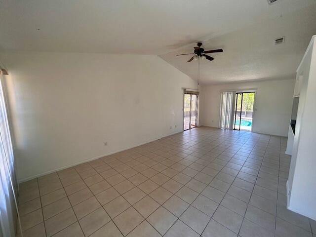 tiled empty room with ceiling fan and lofted ceiling