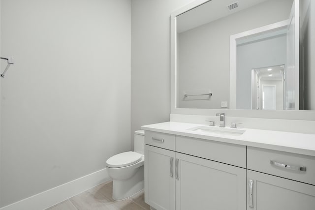 bathroom featuring tile patterned floors, vanity, and toilet