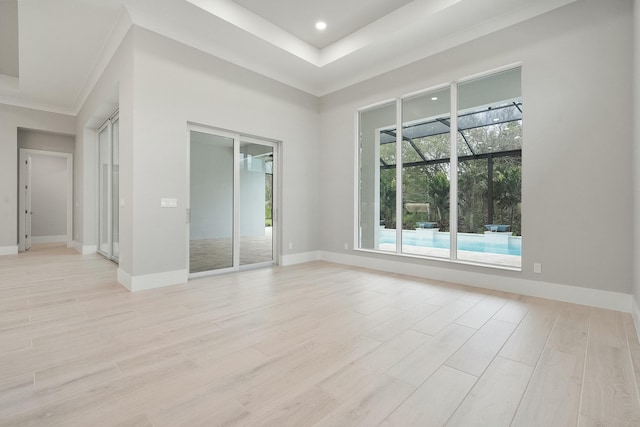 empty room with ornamental molding and light wood-type flooring