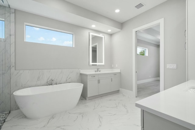 bathroom featuring a washtub and vanity