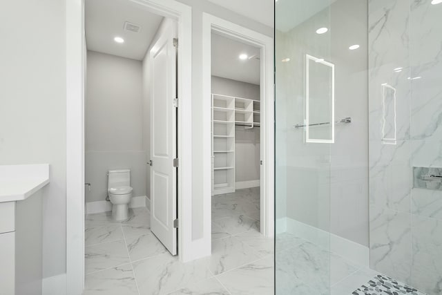 bathroom featuring toilet and a tile shower