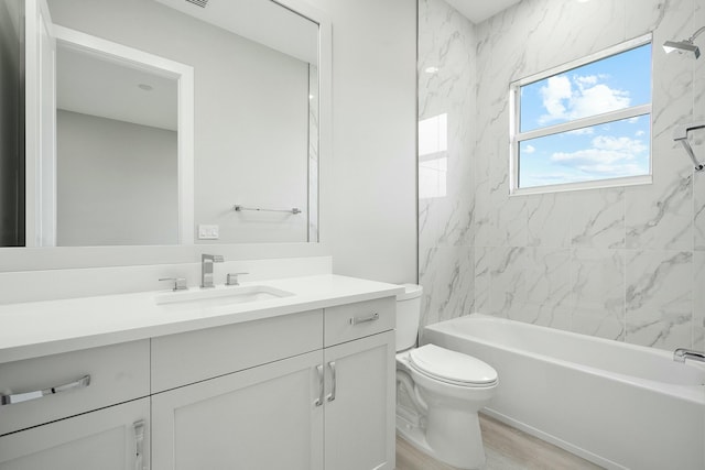 full bathroom featuring wood-type flooring, vanity, toilet, and tiled shower / bath