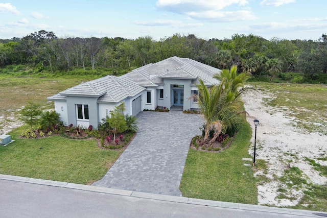 view of front of home with a front yard and french doors