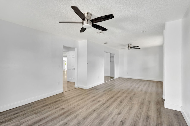 unfurnished living room with ceiling fan, light hardwood / wood-style floors, and a textured ceiling