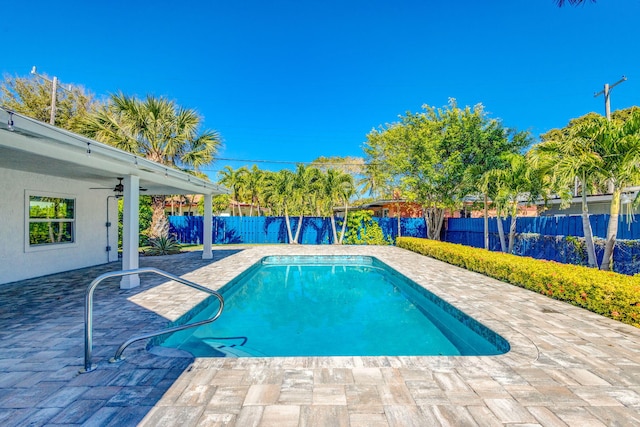 view of swimming pool with a fenced backyard, ceiling fan, a fenced in pool, and a patio