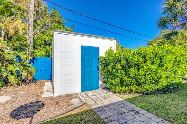 view of shed featuring fence