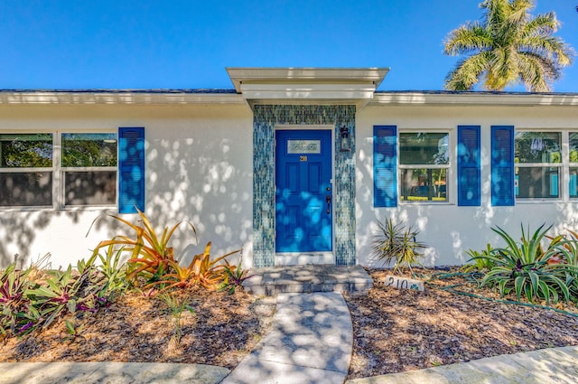 doorway to property with stucco siding