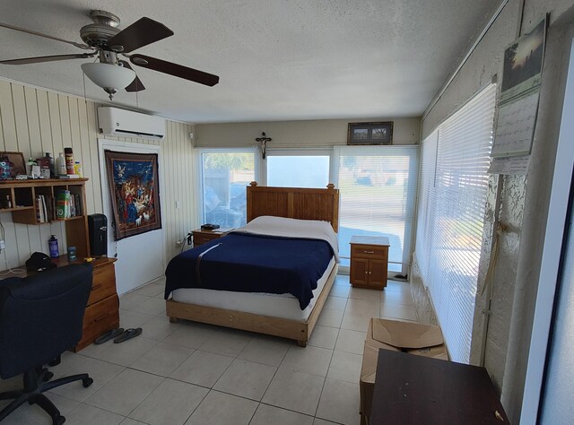 tiled bedroom featuring ceiling fan and a textured ceiling