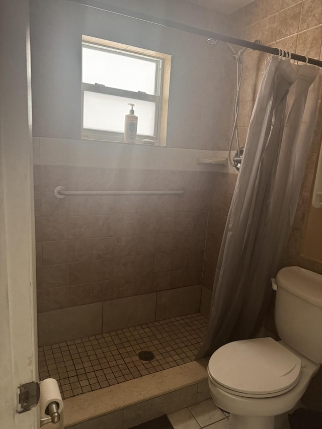 bathroom with toilet, a shower with curtain, and tile patterned floors